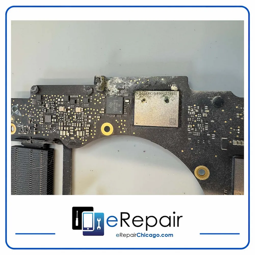 MacBook logic board with visible water damage and corrosion, restored after component replacement