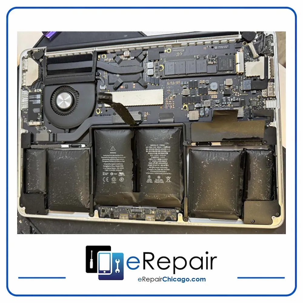 Swollen MacBook battery cells exposed during replacement